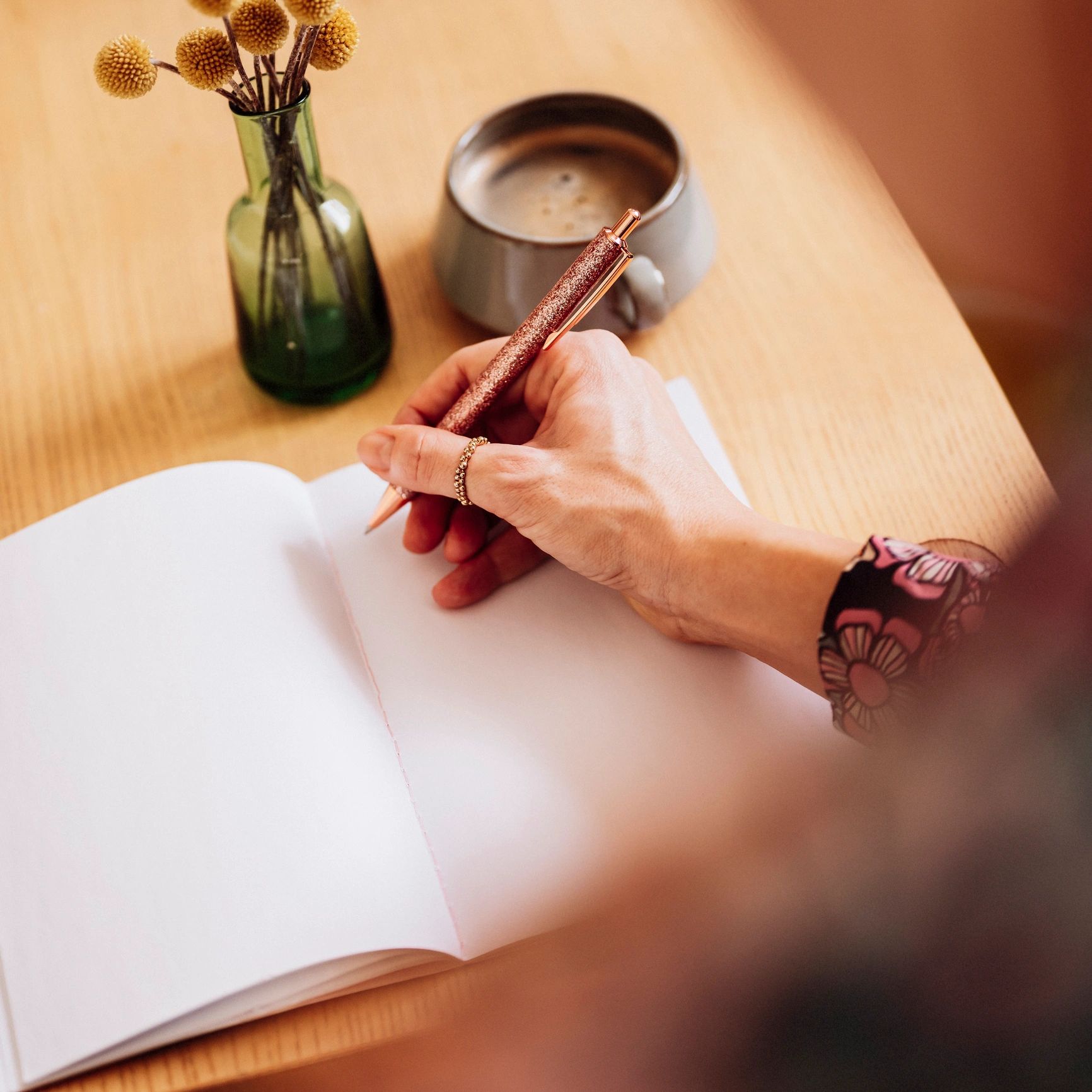 Woman journaling with coffee, planning next steps