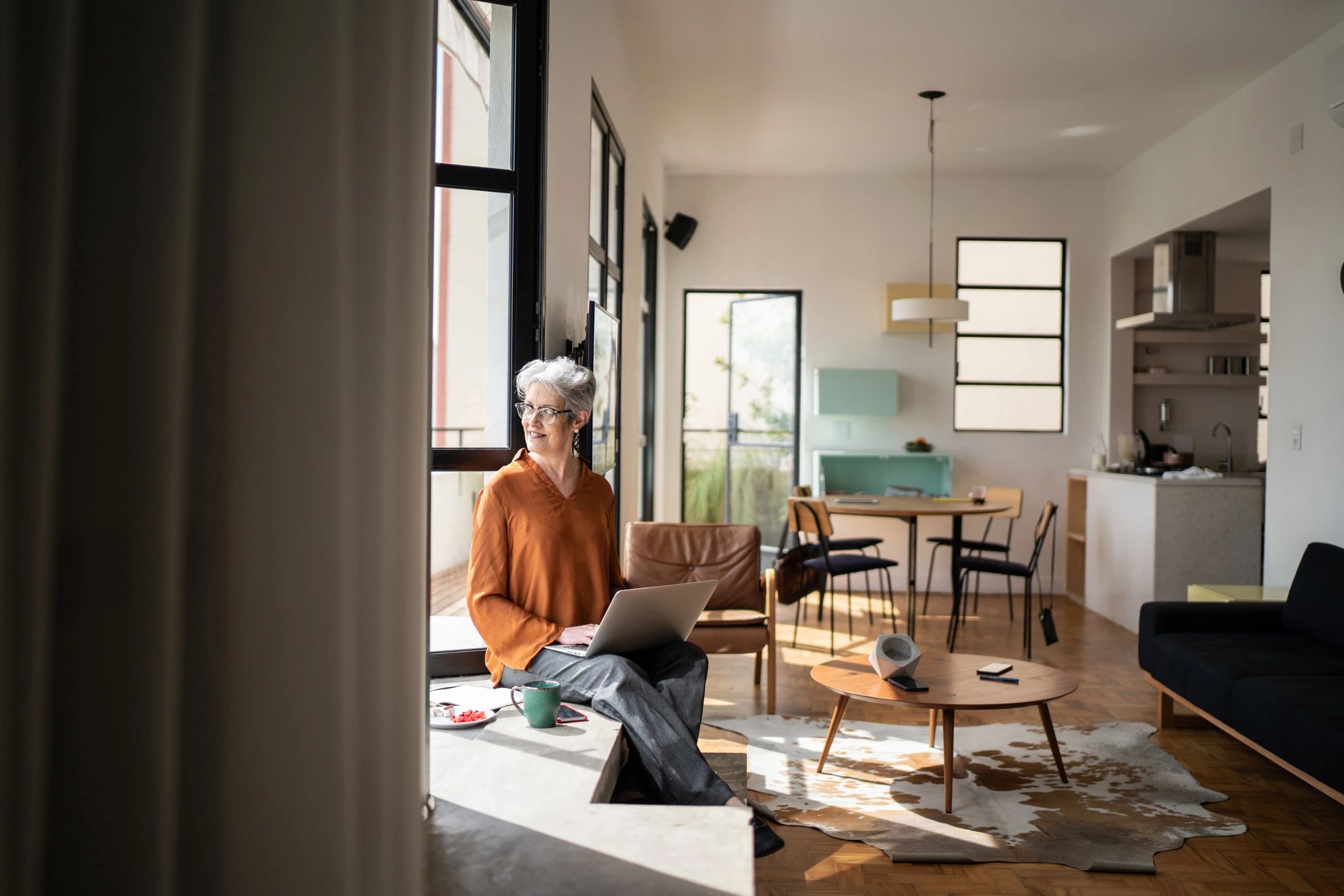Woman on a laptop at home planning goals and next steps