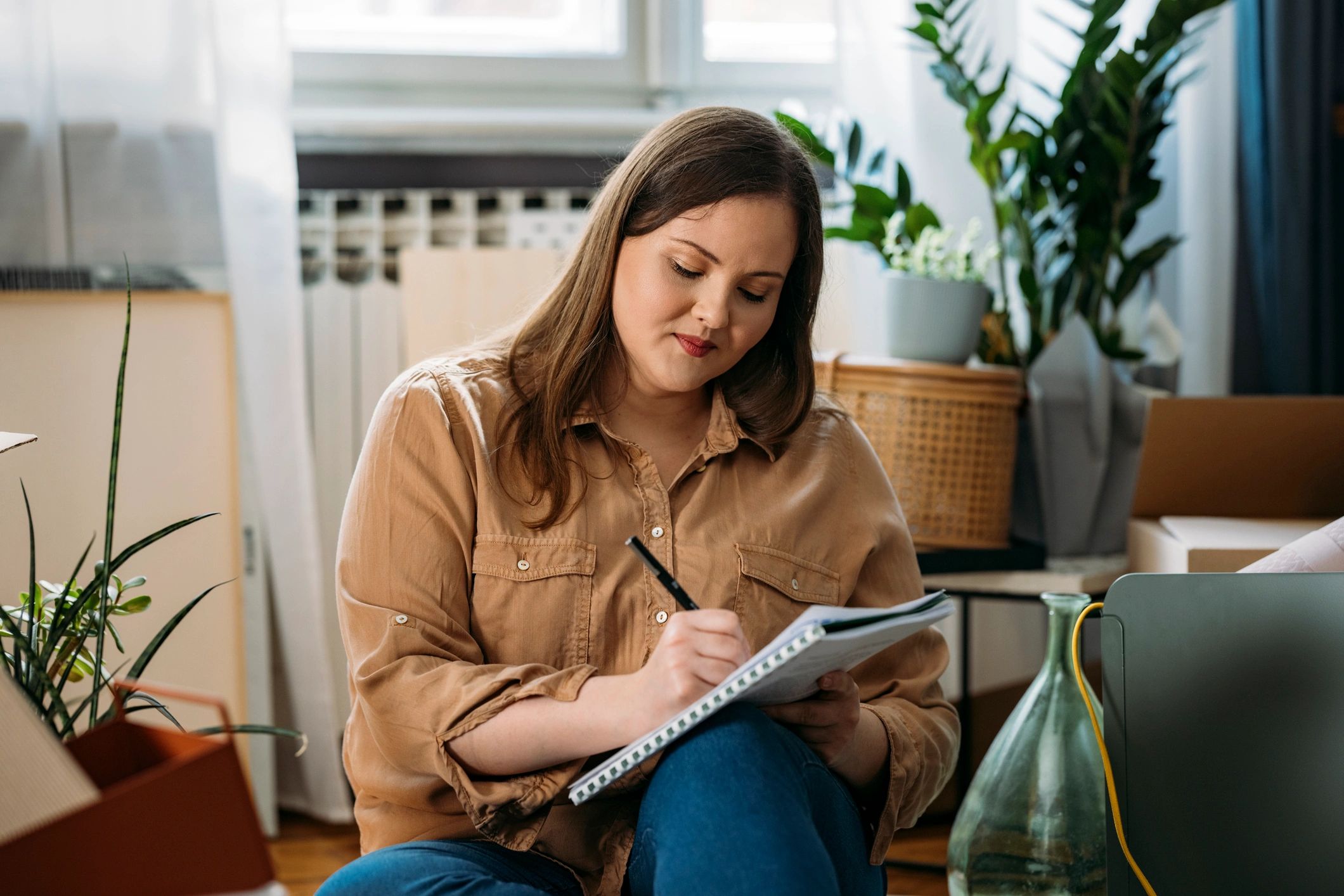 Woman making a checklist at home, representing thoughtful decision-making