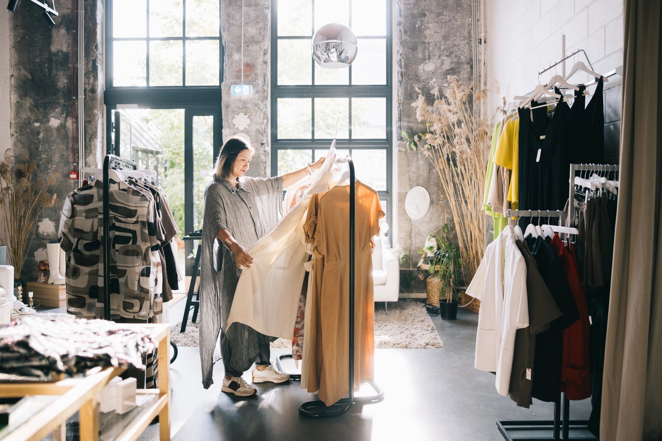Woman browsing dresses in a boutique for a confidence refresh