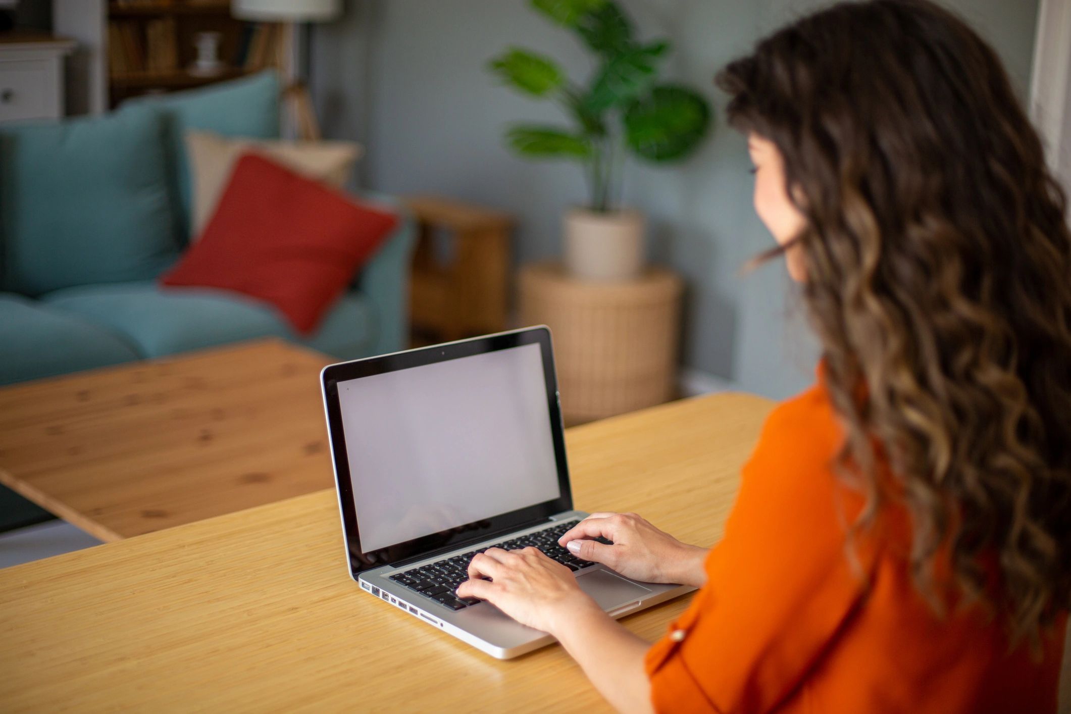 Woman working from home on a laptop at a table